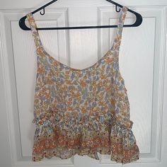 Never Been Worn! Beautiful Boho Style Tank Top. Very Loose Fitting And Light Weight. Small Shimmer Of Gold Details Throughout The Whole Shirt. Orange Floral Print Beach Top, Orange Summer Tank Top For Day Out, Orange Floral Print Tops For Beach Season, Floral Print Crop Top Tank For Vacation, Tank Top Layered, Boho Tank Top, Blue White Top, Style Tank Top, Crochet Tank Top