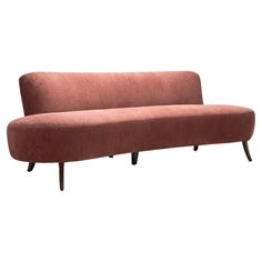 a pink couch sitting on top of a wooden frame