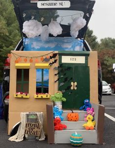 the trunk of a car is decorated with halloween decorations and stuffed animals in front of it