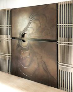 an abstract metal wall sculpture in a room