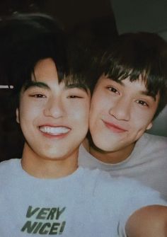 two young boys are smiling for the camera