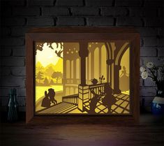 an illuminated shadow box with the silhouettes of two people sitting on a bench