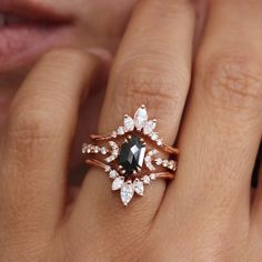 a woman's hand with a ring on it and an emerald stone in the middle