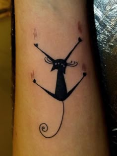 a black cat tattoo on the wrist