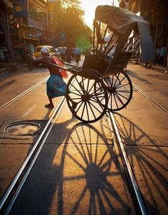 a woman pushing a buggy down the street