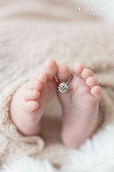 a baby's feet with a ring on it