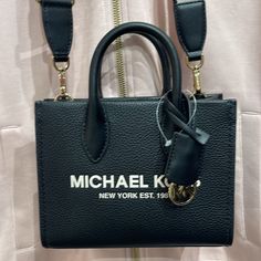 Michael Kors Mirella Extra-Small Xs Shopper Xbody Crossbody Bag Nwt Authentic Mk Xs Whether You’re Heading To A Daytime Event Or Simply Running Errands, The Mirella Will Meet The Moment. Fit All Your Essentials Into This Charming Mini Tote, Which Can Be Carried By The Top Handles Or Worn Cross-Body Thanks To A Removable Strap. Debossed With Our “Mk” Initials And Charm, It’s A Reliable Way To Spice Up Any Outfit. Crossbody Bag Pebble Leather Gold-Tone Hardware 7.25”W X 5.75”H X 2”D Handle Drop: 2 Michael Kors Handbags Black, Michael Kors Satchel, Michael Kors Crossbody Bag, Michael Kors Crossbody, Black Crossbody, Mini Tote, Purses Michael Kors, Black Handbags, Spice Up