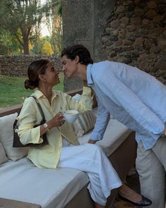 a man and woman kissing on a bench