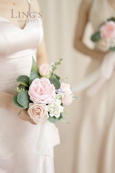 two bridesmaids in white dresses with pink and white flowers