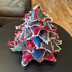 an origami christmas tree on a black table