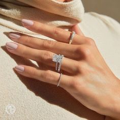 a woman's hand with two rings on it