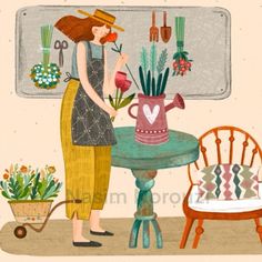 a woman arranging flowers in a vase on top of a table next to a chair