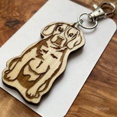 a wooden keychain with a dog on it