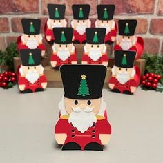 a group of wooden santa claus figurines sitting on top of a table