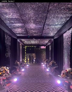 a long hallway with lights and flowers on the floor