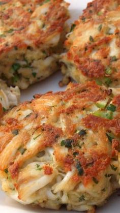 several crab cakes are arranged on a white plate