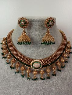 This exquisite piece of craftsmanship comes from our Traditional collection. Finish: 24 grams gold finish Necklace Fastening: Adjustable Dori  Perfect for Indian weddings. Earring jhumka Fastening: Push Back Contains: 1 necklace, 1 pair of earrings Ceremonial Hand Set Gold Plated Bridal Necklace, Ceremonial Hand-set Gold Plated Bridal Necklace, Ceremonial Gold-plated Hand Set Bridal Necklace, Gold Meenakari Bridal Necklace For Formal Occasions, Ceremonial Gold Kundan Necklace Hand Set, Gold Bollywood Jewelry With Intricate Design, Gold Tilla Necklace For Wedding, Gold Hand Set Kundan Necklace For Celebration, Handmade Gold Kundan Necklace For Wedding