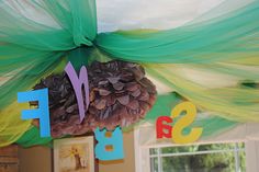 pine cone decoration hanging from the ceiling in a child's room with letters and decorations