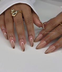 Elevate your summer style with these stunning almond-shaped nails featuring a gold French tip and a delicate crescent moon accent. Perfect for a touch of glam!  #SummerNails #GoldFrenchTips #AlmondNails #NailArt #Manicure #NailInspiration #SummerVibes #NailGoals #NailDesigns #Beauty #Fashion Glam Nails Almond Shape, French Manicure Designs With Gold, Almond Nails Gold French Tip, Almond Nails With Gold Tips, Gold French Manicure Almond, Gold French Tips Almond, Acrylic Nails With Gold Design, Gold Almond French Tip Nails, Almond Gold French Tip Nails