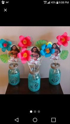 two vases filled with flowers on top of a table