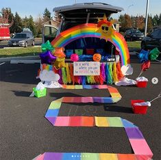 a car is decorated with rainbows and decorations