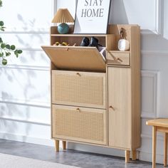 a wooden cabinet with baskets and shoes on it in front of a white painted wall