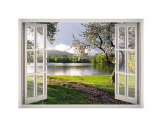 an open window looking out onto a lake and trees in the distance with a dog sitting on the grass