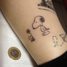 a person with a small tattoo on their arm and the image of a dog is drawn on it