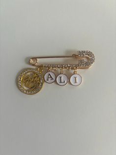 a gold and white brooch with the number four on it's back side