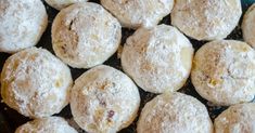 several powdered sugar donuts are piled on top of each other