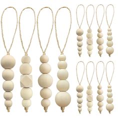 several wooden beads hanging from strings on a white background