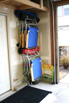 there is a rack full of luggage in the garage