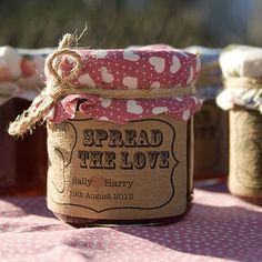 some jars are sitting on a table with pink and white polka dot fabric around them