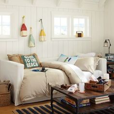 a living room filled with furniture and lots of pillows on top of the couches