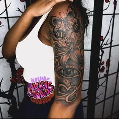 a woman with a black and grey tattoo on her arm