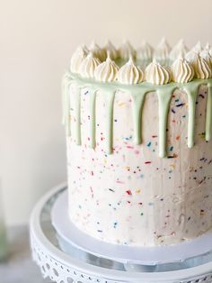 a birthday cake with white frosting and sprinkles