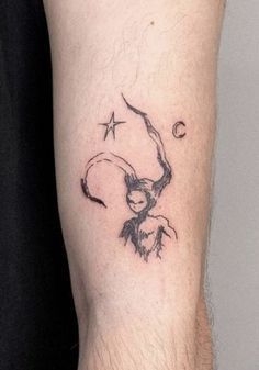 a man's arm with a tattoo on it that has an image of a woman flying through the sky