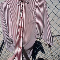 Beautiful striped blouse with a detachable bow tie. White and brown, the brown is deep and rich, with a redish cast. Fluid dolman sleeves finish with 3 button cuffs and a single box pleat in the back. Straight hem. Buttons up the front, hidden. Made in France by Rodier, late 1970s to early 1980s with a 1930s influence. Size 40 which translates into a medium US, size 8. Made of polyester. Extra button sewn into the blouse. Fine vintage condition with no tears or stains. Measurements: Collar - 15 Elegant Striped Fall Blouse, Elegant Striped Blouse For Fall, Fall Workwear Striped Blouse, Fall Striped Blouse For Work, Striped Blouse For Workwear In Fall, Fall Striped Fitted Blouse, Fitted Striped Blouse For Fall, Classic Vertical Stripes Blouse For Fall, Vertical Stripes Tops For Spring Formal Occasions