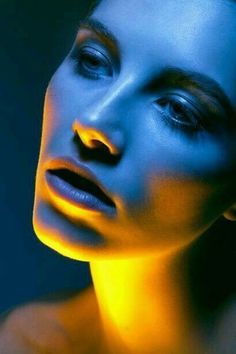 a woman with blue and yellow light on her face