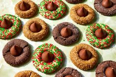 there are many cookies with chocolate and sprinkles on the top one has an egg in it