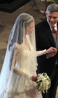 the bride and groom are walking down the aisle at their wedding ceremony in black and white