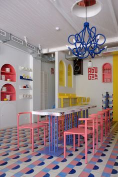 a room with colorful tables and chairs in it