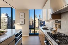 a kitchen with a stove top oven next to a window filled with lots of windows