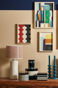 a wooden table topped with vases and lamps