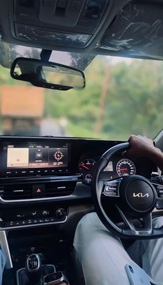 the interior of a car with dashboard, steering wheel and electronic display on the dash