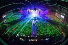 an aerial view of a concert venue with green and purple lights in the middle of the room