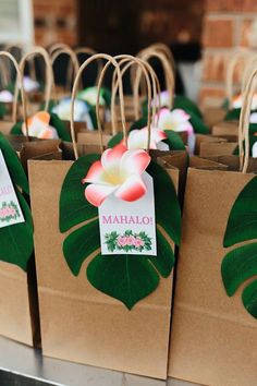 some paper bags with flowers and leaves on them