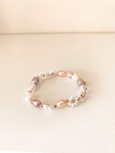 Delicate and feminine, our Eva Bracelet is the perfect everyday piece. Featuring 8mm freshwater pearls framed with our golden white daisies, this bracelet will make you feel confident and absolutely sparkle. Materials: A mix of 8 mm freshwater pearls, white glass seed bead daisies, 3 mm & 4 mm gold filled bead accents Rose Gold Beaded Bracelets With Pearl Charm, Rose Gold Pearl Beaded Bracelets, Everyday White Pearl Beaded Bracelets, Feminine White Bracelets With Pearl Charm, Feminine White Pearl Bracelets, Elegant Everyday Cream Bracelets, Feminine White Pearl Bracelet, Feminine Adjustable White Pearl Bracelet, Adjustable Feminine White Pearl Bracelet