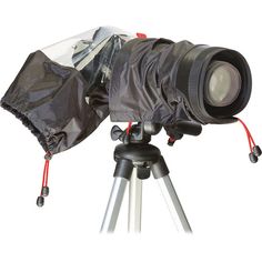 a camera on a tripod with a bag over it