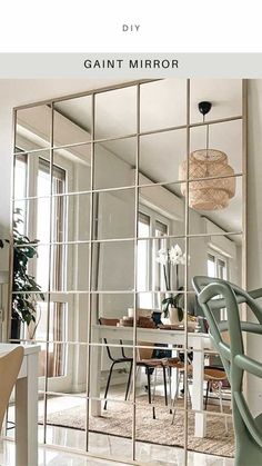 a large mirror sitting in the middle of a living room next to a dining room table